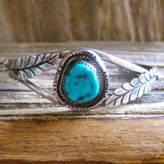 DESCRIPTION: Antique collectible Navajo artisan handmade sterling silver unisex design cuff bracelet with large turquoise stone with desirable matrix. According to experts, at this date, there is not enough Turquoise being mined to fill the domestic or the international demand, and most of the top mines have closed. Turquoise is becoming rare. This kind of vintage quality is why we love it so much...heavy sturdy precious metal, handmade artisan craftsmanship and distinctive design.  You will lov Artisan Adjustable Untreated Jewelry, Untreated Adjustable Artisan Jewelry, Handmade Western Sterling Silver Cuff Bracelet, Handmade Western Sterling Silver Bracelet For Gift, Bohemian Sterling Silver Adjustable Engraved Bracelet, Artisan Hand-tooled Jewelry Bracelet, Handmade Adjustable Sterling Silver Bracelet Collectible, Untreated Southwestern Jewelry Collectible, Untreated Western Style Jewelry For Gifts