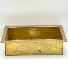 a golden rectangular metal container on a white background