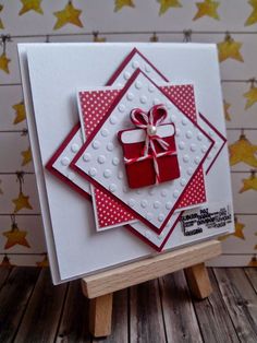 a close up of a card on a wooden stand with stars in the back ground