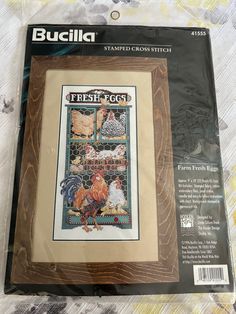 a cross stitch pattern on the back of a package with an image of chickens and roosters