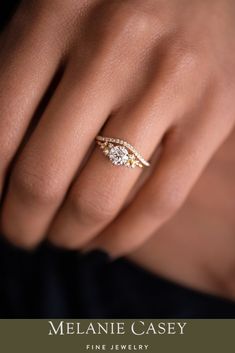 a woman's hand with a diamond ring on her finger and the words melanie casey fine jewelry