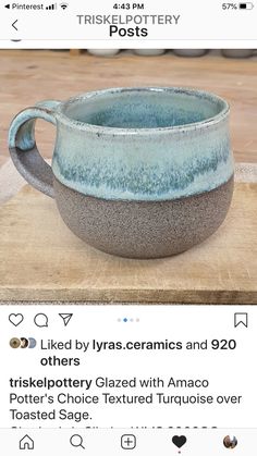 a blue and white cup sitting on top of a wooden table