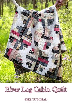 the river log cabin quilt pattern is hanging on a clothesline in front of some trees