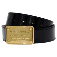 The Dolce & Gabbana black patent leather belt is a sophisticated accessory that exudes elegance and luxury. Featuring a buckle engraved with "Women's Collection Via San Damiano, 7 - Milano Italia," this belt is a testament to the brand's impeccable Italian craftsmanship. Its glossy patent leather finish gives it a dressy appearance, making it ideal for elevating a casual outfit. This belt can seamlessly transition from day to night, pairing beautifully with a designer blouse from Versace and tai Designer Black Belts With Metal Logo, Designer Black Belt With Gold Buckle, Chic Black Belt With Gold-tone Logo Plaque, Dolce And Gabbana Devotion Belt, Designer Black Belt With Gold-tone Logo Plaque, Dolce And Gabbana Handbags, Pink Monogram, Stefano Gabbana, Leather Finish