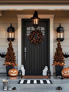 front porch decorated for halloween with pumpkins and decorations