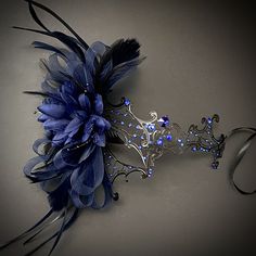 Masquerade masks in black/blue. Simplistic for woman with a blue floral- destined to pop out at any event, wedding etc The black/blue women mask is veil decoration with feather and blossoming branches. This masquerade mask is great for any occasion. Dark Blue Masquerade Mask, Blue Masquerade Mask, Masquarade Mask, Masquerade Outfit Ideas, Masquerade Halloween Costumes, Masquerade Mask Women, Masquerade Outfit, Masquerade Ball Mask, Female Mask