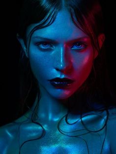 a woman with blue and red light on her body