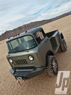 an off - road vehicle is parked in the desert