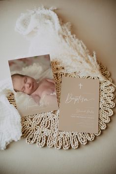 a baby's birth announcement is displayed on a doily next to a card