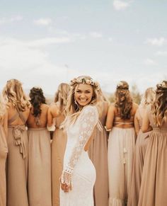 the bridesmaids are all wearing brown dresses and one is standing in front of her