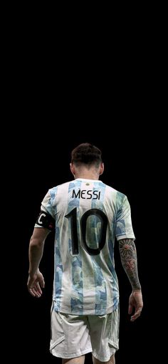 a man with tattoos on his arms and legs is wearing a soccer jersey that says messi