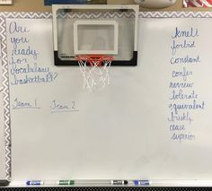 a white board with writing on it and a basketball hoop hanging from the backboard