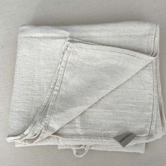 the folded linen is white and has a tag on it