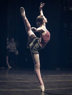 a woman is doing an acrobatic move on the dance floor