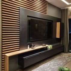 a tv is mounted on the wall in front of a wooden paneled entertainment center