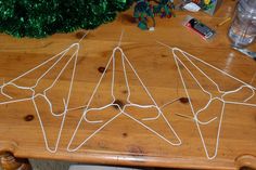 a wooden table topped with white string art