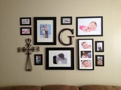 a living room wall with many pictures on the wall and a crucifix