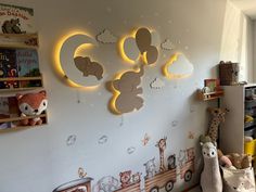 a child's room with teddy bears and lights on the wall, along with other children's toys