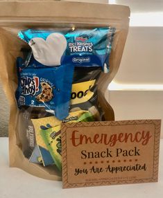 an emergency snack pack is packed in a brown paper bag