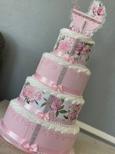 a three tiered cake with pink flowers on it