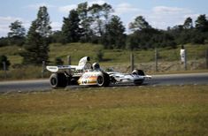 a man driving a race car down a road