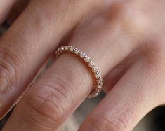 a woman's hand with a diamond ring on it