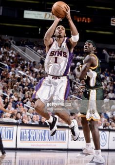 an image of a basketball player going to dunk the ball in front of another player