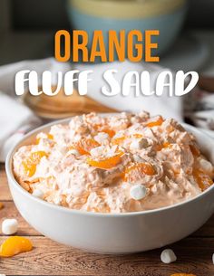 orange fluff salad in a white bowl on a wooden table