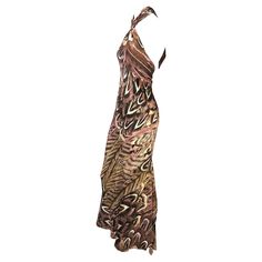 Presenting a beautiful feather print Roberto Cavalli gown. From the Spring/Summer 2005 collection, this halterneck dress is constructed entirely of a feather print silk that features a variety of pink and brown hues. The dress ties at the nape and is made complete with an exposed back and flared hem. Approximate measurements: Size - IT40 63" total length 34" bust 30" waist 43" hips 100% silk Roberto Cavalli Dress, Backless Gown, Business Concept, Feather Pattern, Pink And Brown, Silk Print Dress, Vintage Maxi Dress, Feather Print, Winter Fits