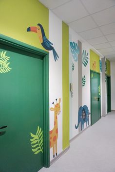 an empty hallway with painted animals and plants on the walls