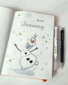 an open notebook with a cartoon character drawn on it and a pen next to it