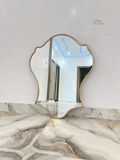 a mirror sitting on top of a marble counter