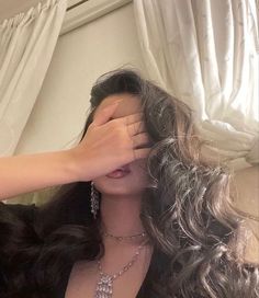 a woman with long hair covering her eyes