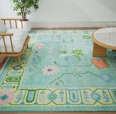 a green rug with flowers on it in a living room