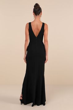 a woman in a black dress looking back