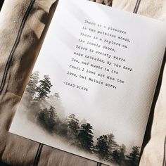 a piece of paper with a poem on it sitting on top of a bed next to a pillow