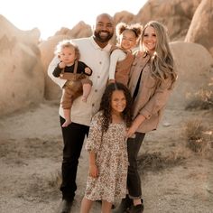 a family posing for a photo in the desert