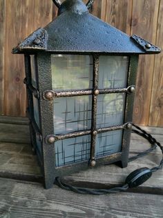 an old fashioned lantern is sitting on the ground