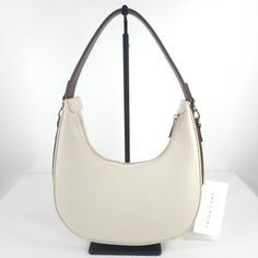 Nwt Trina Turk Leather Off Wht / Brown Crescent Hobo Handbag Logo Accents, Gold Tone Hardware, Top Carry Handle, Stitched Trim, Embossed Brand Logo Detail 10in W X 6in H Zip Closure 1 Front Zip Pocket, 1 Interior Zip Pocket Leather Exterior Top Handle Top Closure Circle Hobo Silhouette Super Cute !! Fast Shipping Welcome Offers & Counteroffers Item Stored In A Place Free Of Smoke And Pets Feel Free To Send Me Any Questions Please Review All Photos And Zoom In To See The Exact Condition, Details White Crossbody Baguette Bag For Shopping, White Baguette Crossbody Bag For Shopping, White Handheld Shoulder Bag For Errands, White Hobo Shoulder Bag For Daily Use, White Crossbody Hobo Bag For Daily Use, White Hobo Bag For Daily Use, Chic White Rectangular Hobo Bag, White Crochet Shoulder Bag, White Hobo Shoulder Bag With Removable Pouch