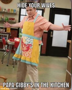 a man wearing an apron standing in a kitchen