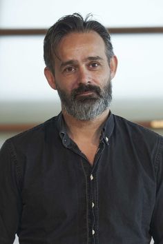 a man with a beard and black shirt