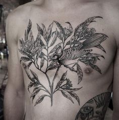 a man's chest with a bird and flowers on it