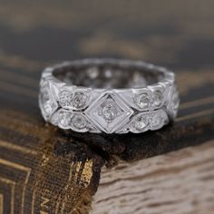 a close up of a wedding ring on top of an old book with the background textured