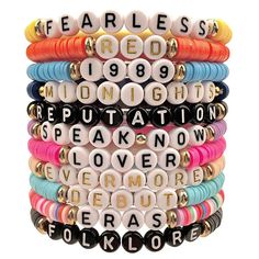 a stack of bracelets with words written in different colors and sizes on each strand