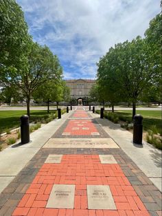 the walkway is lined with bricks and trees