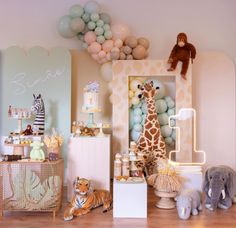 an animal themed birthday party with balloons and decorations