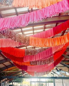 colorful streamers hanging from the ceiling in a building