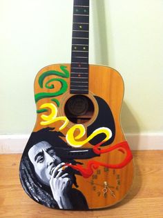 a wooden guitar with a painting on it