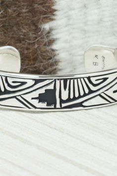 This sterling silver and bracelet was made by Navajo silversmith Kerry Begay. The inside is signed KB and stamped sterling.Size: 5" (will fit up to a 6" wrist)Gap: 1"Width: 1/2"Free shipping on all orders! We ship with USPS and always include tracking. All orders ship within a day of payment.Returns are accepted up to 30 days after you receive your order. Just send us a message. Our shop offers cash back or store credit. The item must be returned in new condition. Artisan Sterling Silver Bangle Bracelet, Artisan Sterling Silver Cuff Bracelet With Engraving, Artisan Sterling Silver Engraved Cuff Bracelet, Artisan Engraved Sterling Silver Cuff Bracelet, Southwestern Sterling Silver Bracelet Stamped 925 As Gift, Artisan Silver Cuff Bracelet With Inlay, Southwestern Style Etched Sterling Silver Bracelet, Artisan Silver Bracelets With Inlay, Unique Etched Sterling Silver Bracelets