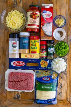 the ingredients for an italian meatloaf recipe laid out on a wooden table top